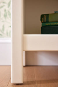Closeup of a one drawer nightstand finished with a white Benjamin Moore paint.