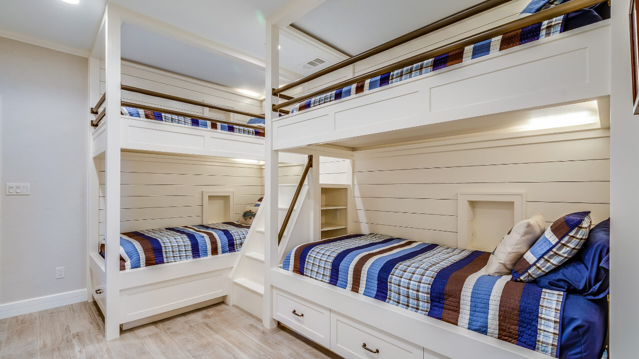 Two bunk beds with connecting stairs and drawer space