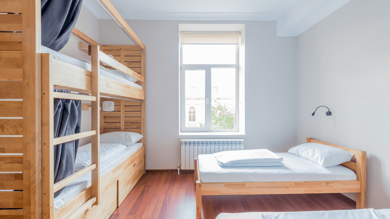A large bunk bed with another bed with matching wooden framework 